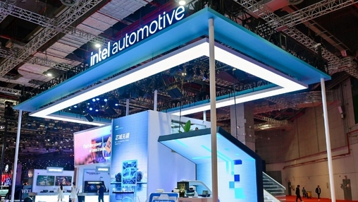 Intel Automotive booth with a glowing blue overhead structure and product displays at a technology exhibition