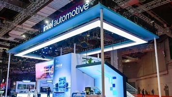 Intel Automotive booth with a glowing blue overhead structure and product displays at a technology exhibition